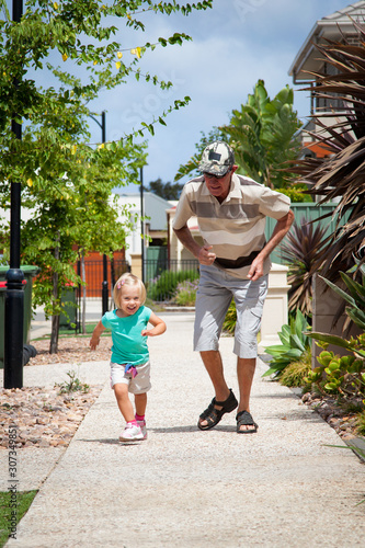 Grandfather and granddaughter playing