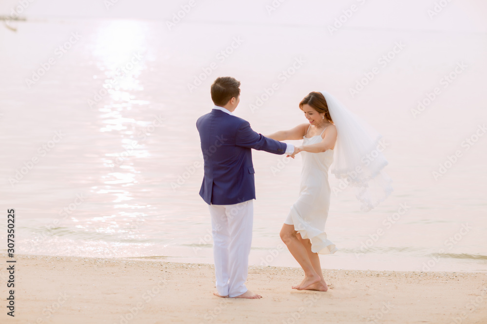 Young asian groom and bride posing and smiling for pre-wedding shot Young asian groom and bride posing and smiling for pre-wedding shot
