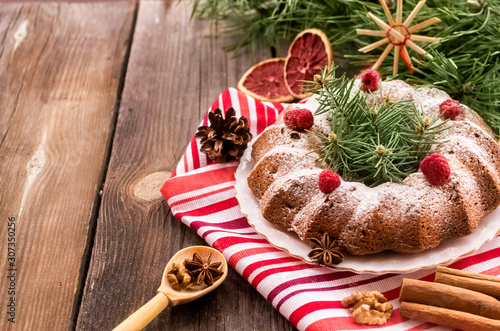 Dairy-free dessert Christmas cake with raisins and raspberries.Natural decorations and gifts from Kraft paper.Zero Waste Christmas.copy space