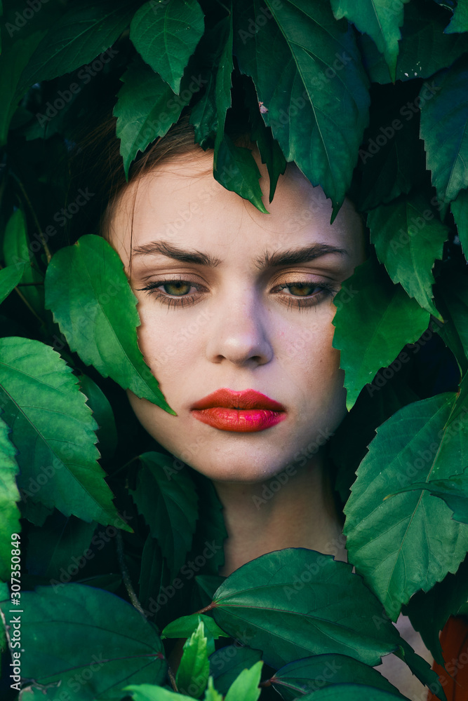beautiful woman on green leaves park nature beautiful woman on green leaves park nature