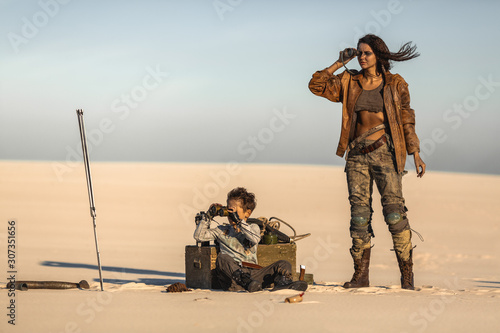 Fényképezés Post apocalyptic Woman and Boy Outdoors in a Wasteland