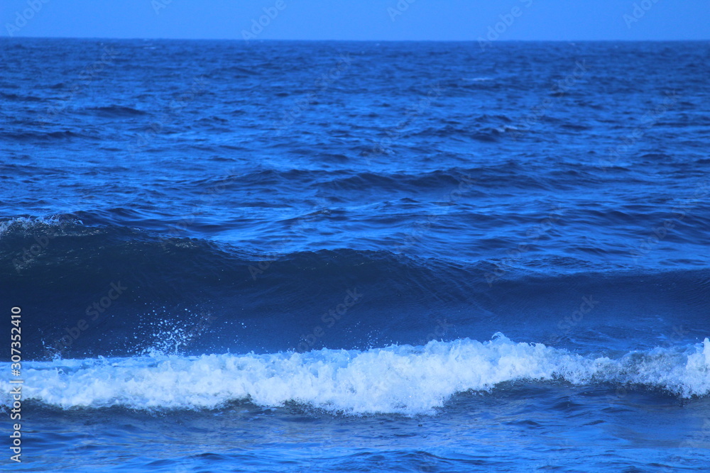 Dark blue color sea or beach water in the evening at chennai marina beach with some waves