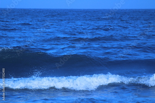 Dark blue color sea or beach water in the evening at chennai marina beach with some waves