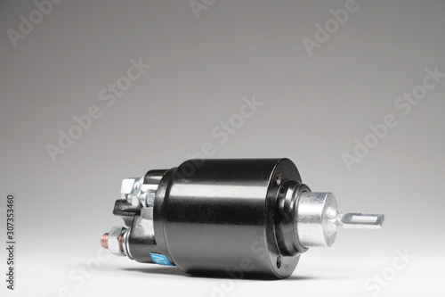New black solenoid for a starter for a car on a gray gradient background. Auto parts. Starter Parts photo