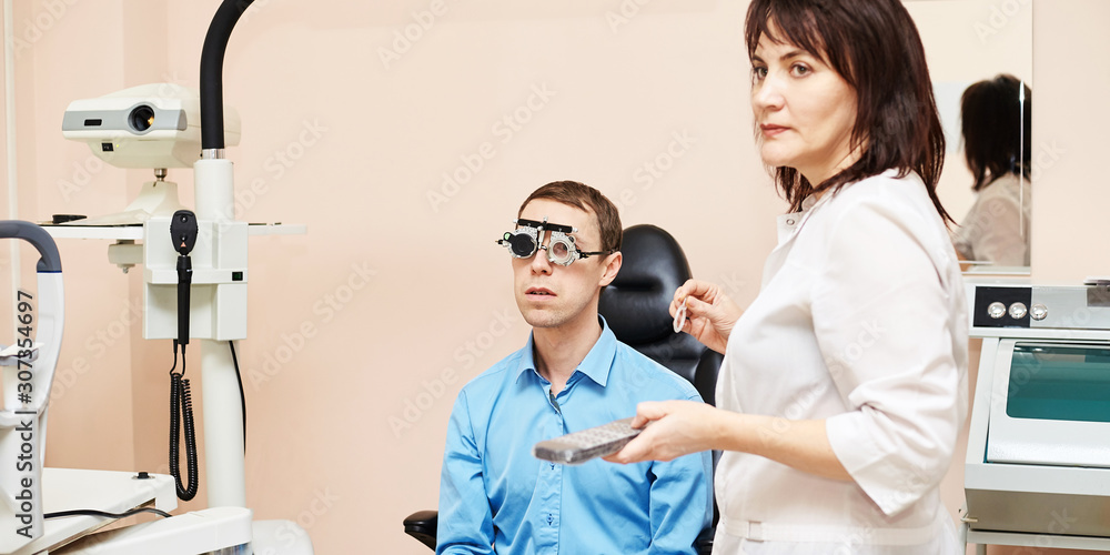 Fototapeta premium ophthalmologist doctor in exam optician laboratory with male patient. Men eye care medical diagnostic. Eyelid treatment