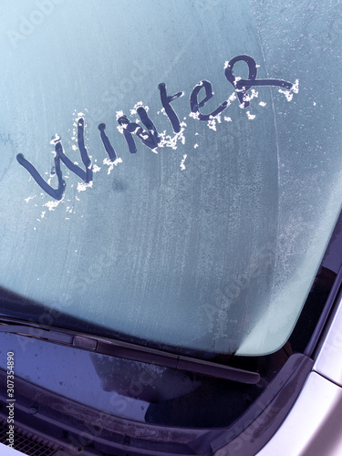 Winter written in the ice on a car windscreen on a cold frosty morning