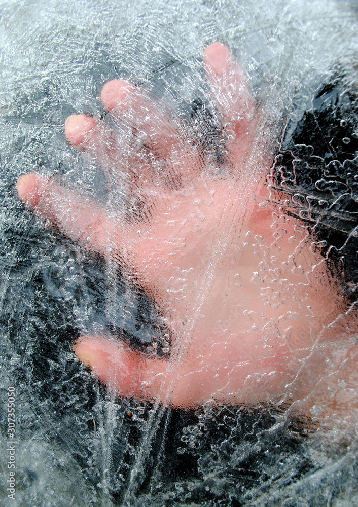 Hand under a layer of ice. Man under the ice. Save the drowning under the ice.