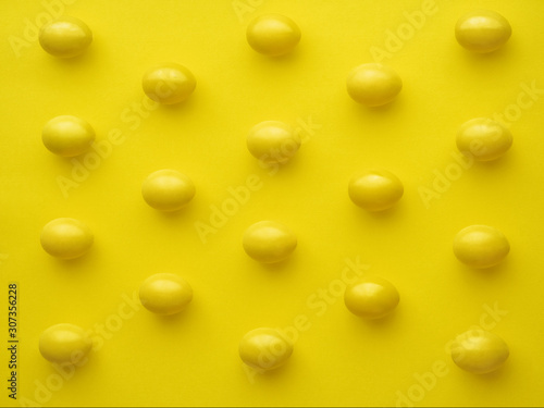 Pattern Of Chicken Eggs In Line Against Yellow Background