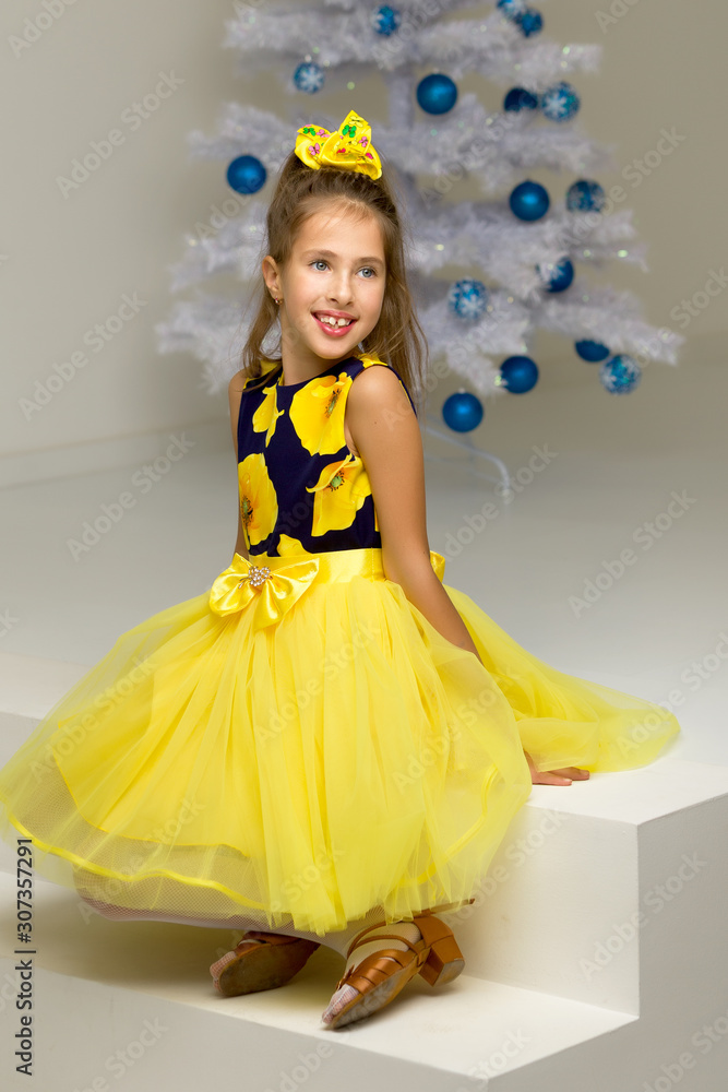 The girl at the Christmas tree.Beautiful little girl near the Ch The girl at the Christmas tree.Beautiful little girl near the Ch