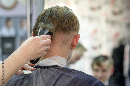 Russia, St. Petersburg, 25.10.2019: a guy in a Barber shop sitting in front of a mirror