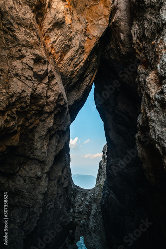 Famous Hanzova pot rock window, Via ferrata climbing path landscape in Vršič pass in Slovenia, in between Mojstrovka and Prisojnik mountain, in beautiful weather