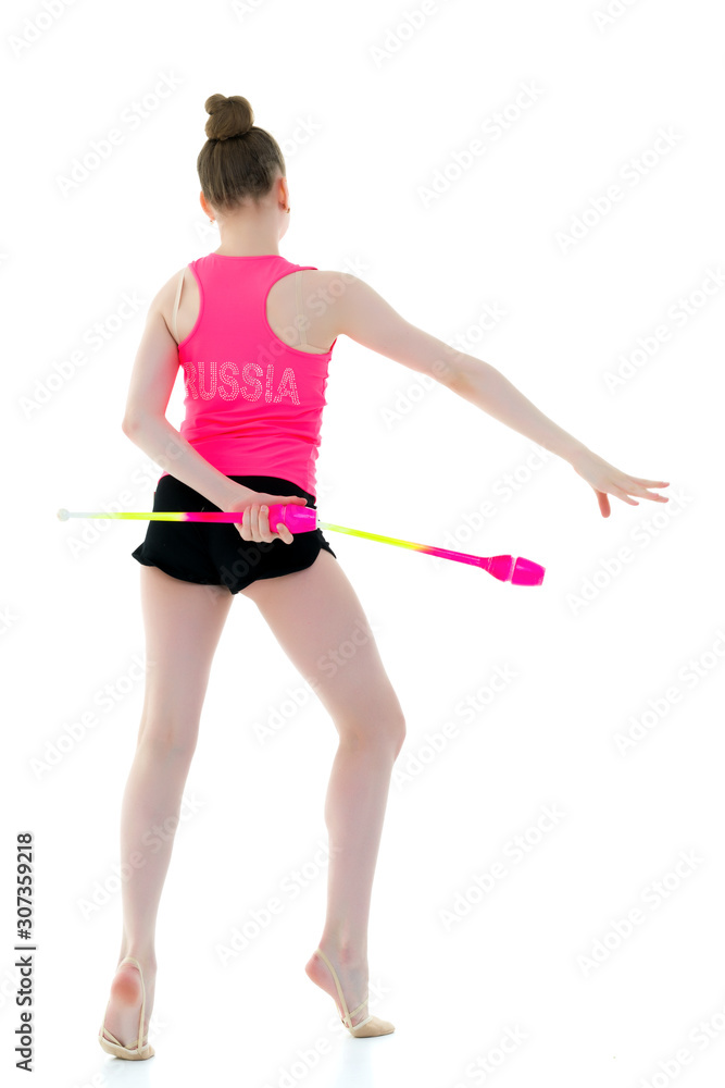 A girl gymnast performs exercises with a mace. A girl gymnast performs exercises with a mace.