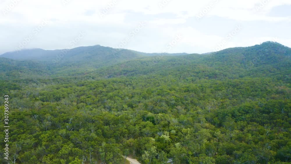 Aerial, beautiful view on the road and a Davies creek in the middle of rain forest at in Queensland, Australia Aerial, beautiful view on the road and a Davies creek in the middle of rain forest at in Queensland, Australia
