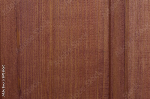 Background from boards of red color. Thick wallpaper from oak planks. Abstract old decorative element.