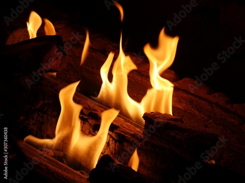 Dancing tongues of flames from logs burning in a fireplace