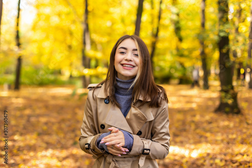 Portrait of an autumn woman with yellow leaves and smiling