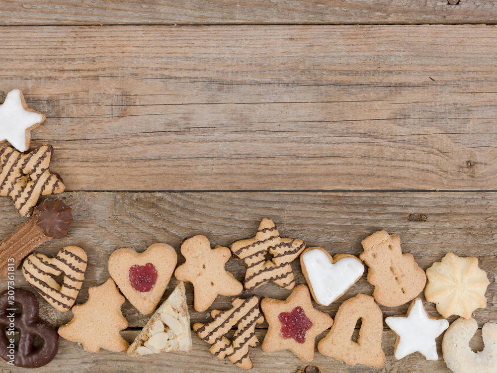 many different nice christmas cookies on wooden background photo taken from above many different nice christmas cookies on wooden background photo taken from above