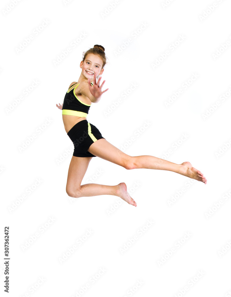 Flexible cute little girl child gymnast jumping and having fun isolated on a white background