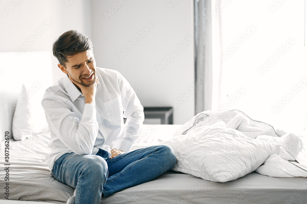 man sitting on sofa at home man sitting on sofa at home