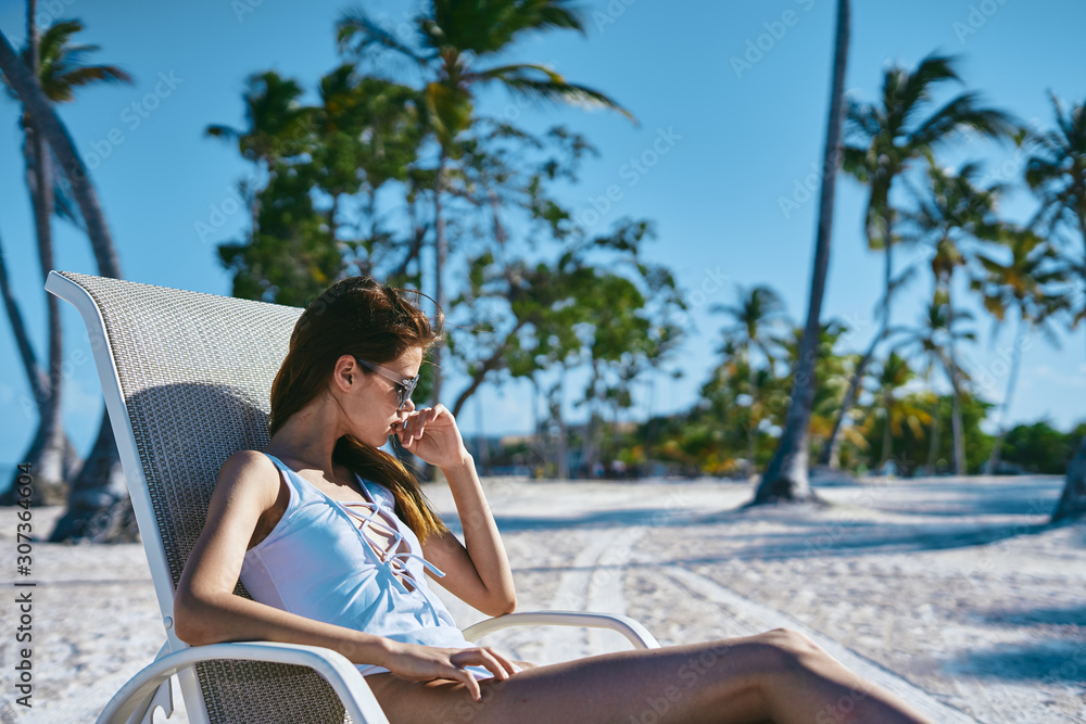 young woman with laptop on the beach