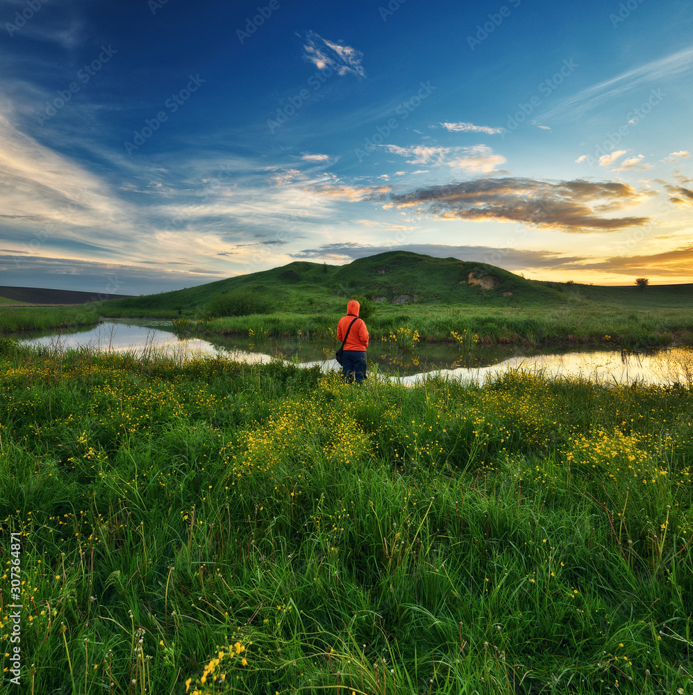 tourist on the hill. a traveler alone with nature. tourist enjoys the view tourist on the hill. a traveler alone with nature. tourist enjoys the view