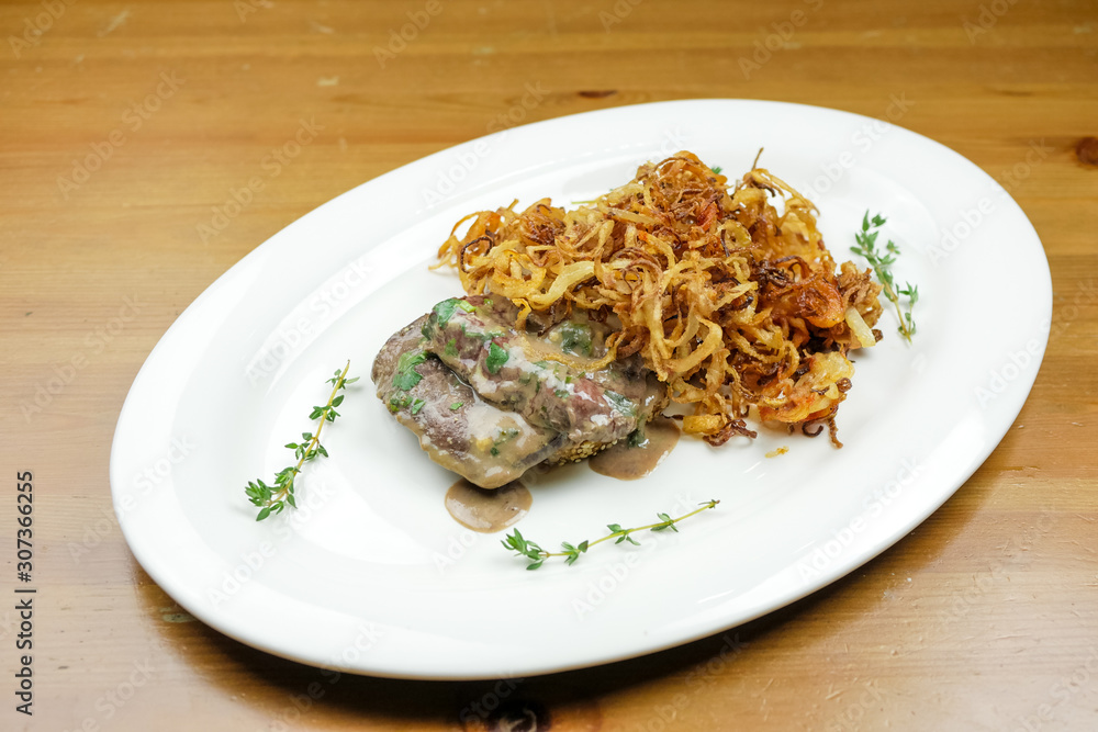 Pork dish on a restaurant table Pork dish on a restaurant table