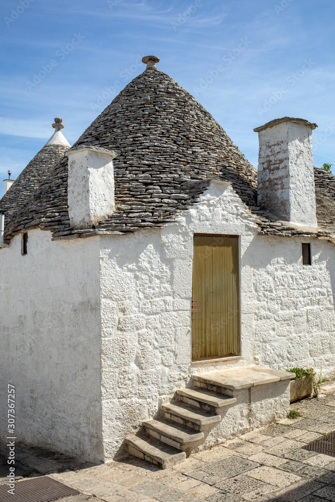 Trulli village in Alberobello, Italy. The style of construction is specific to the Murge area of the Italian region of Apulia (in Italian Puglia). Made of limestone and keystone.