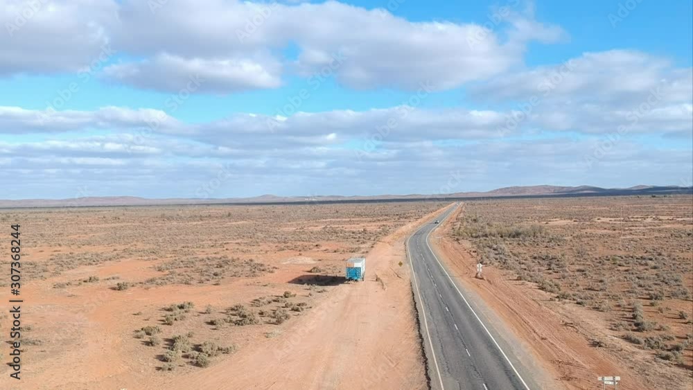 A car approaches down a long straight road A car approaches down a long straight road