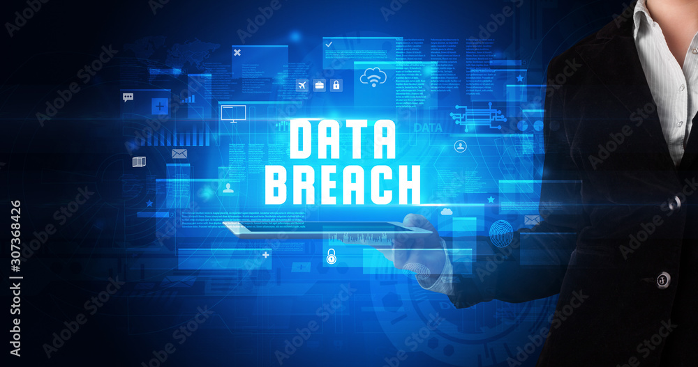 Young business person working on tablet and shows the digital sign: DATA BREACH Young business person working on tablet and shows the digital sign: DATA BREACH