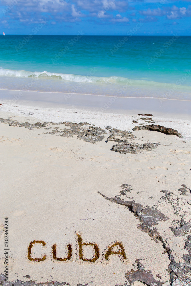 Inscription cube on the dense sand of the beach.Horizontally.Vertically. Inscription cube on the dense sand of the beach.Horizontally.Vertically.