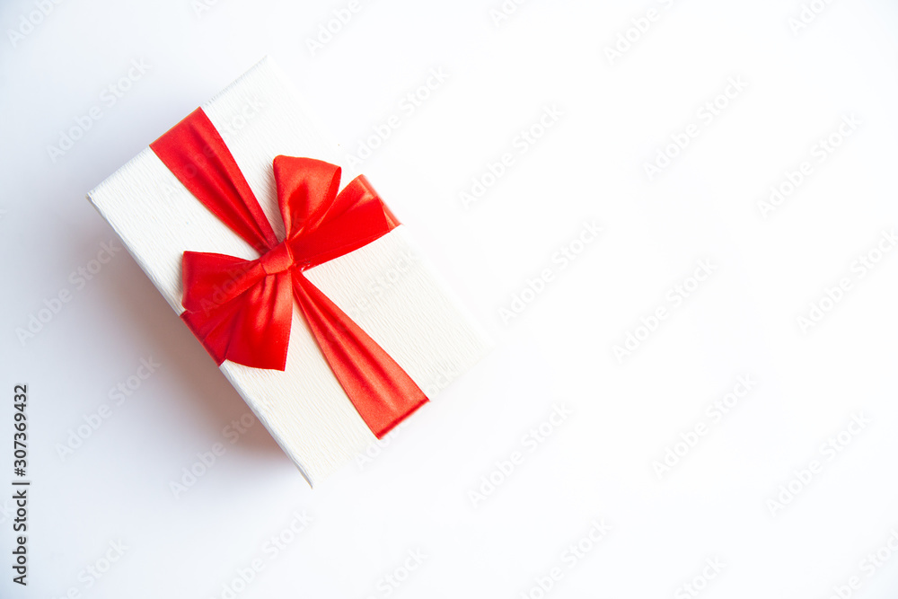 Beautiful Christmas gift box with red ribbon on isolated background. Happy New Year and merry christmas. Beautiful Christmas gift box with red ribbon on isolated background. Happy New Year and merry christmas.