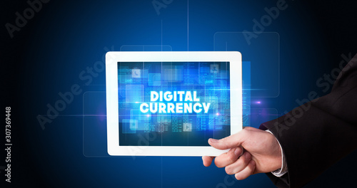 Wallpaper Mural Young business person working on tablet and shows the inscription: DIGITAL CURRENCY Torontodigital.ca
