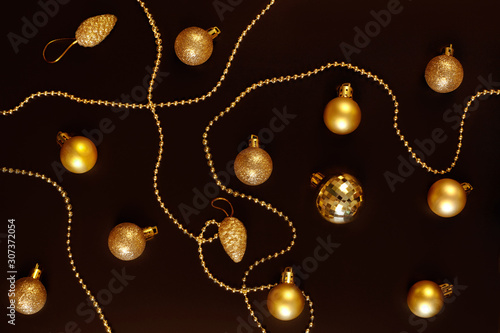 Golden christmas decorations on dark background.