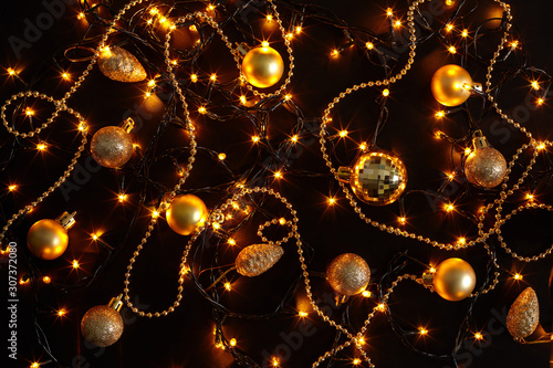 Golden lights and christmas decorations on dark background.