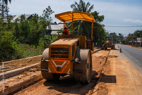 Road rollers working on the new roads construction site. Heavy duty machinery working on highway. Construction equipment. Compaction of the road.