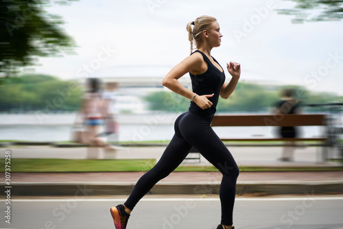 Calm adult runner training in park