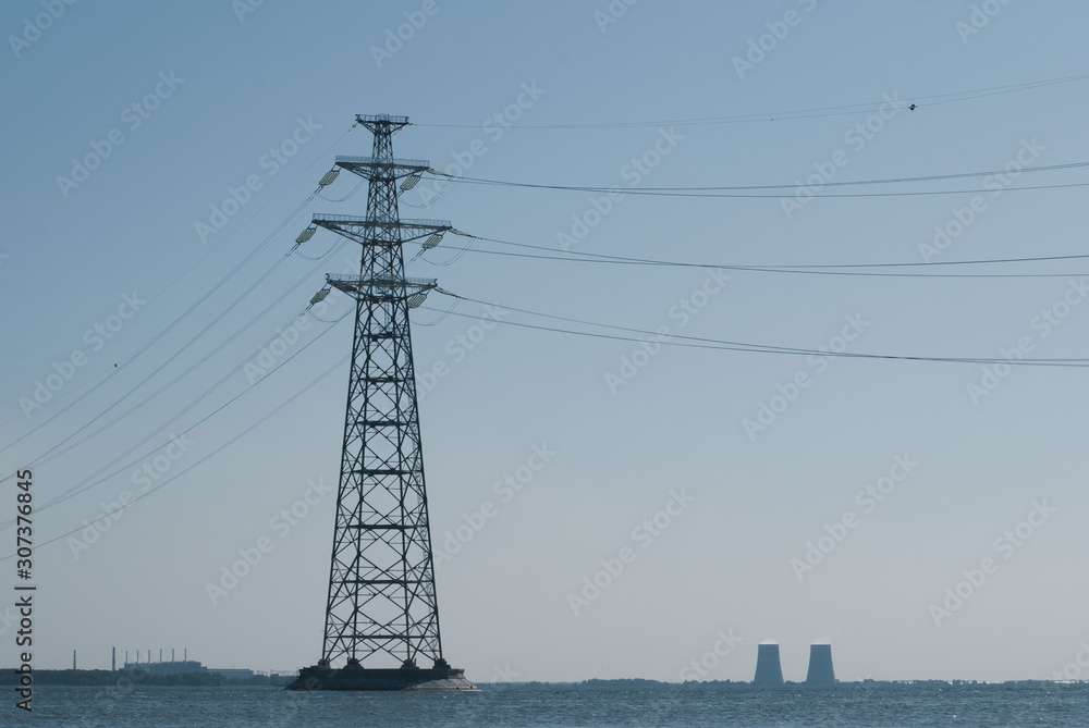 Electric pillar in the river. High voltage line,