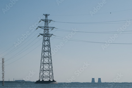 Electric pillar in the river. High voltage line, © vulkanov