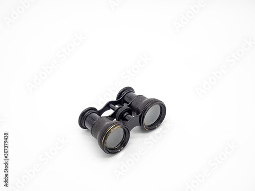 Antique opera glasses isolated on white background. Black small vintage binoculars.