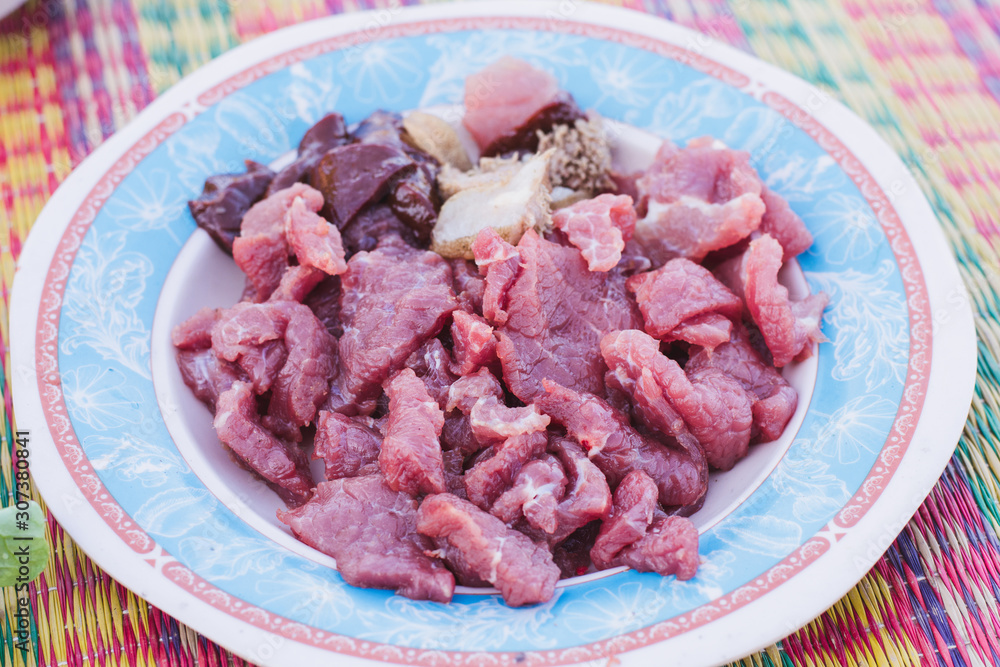 Raw meat with onions on a plate