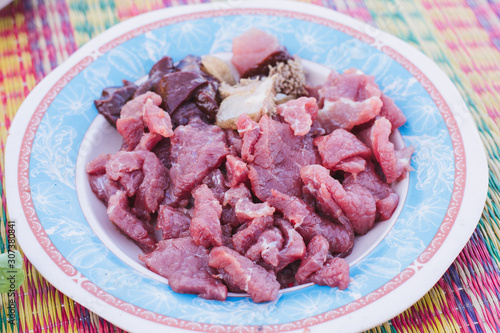 Raw meat with onions on a plate