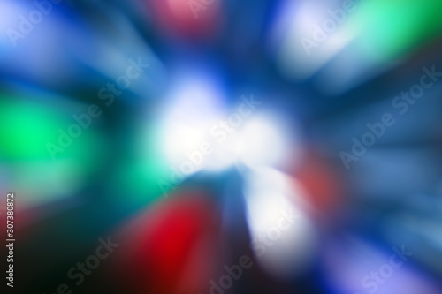 Blurred lights dark blue, red, green, white background. Abstract soft explosion effect. Centric motion pattern