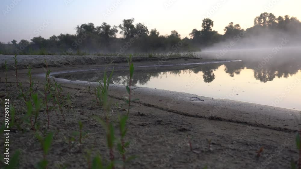 Early morning. Fog above the water. Grass in the dew. Early morning. Fog above the water. Grass in the dew.
