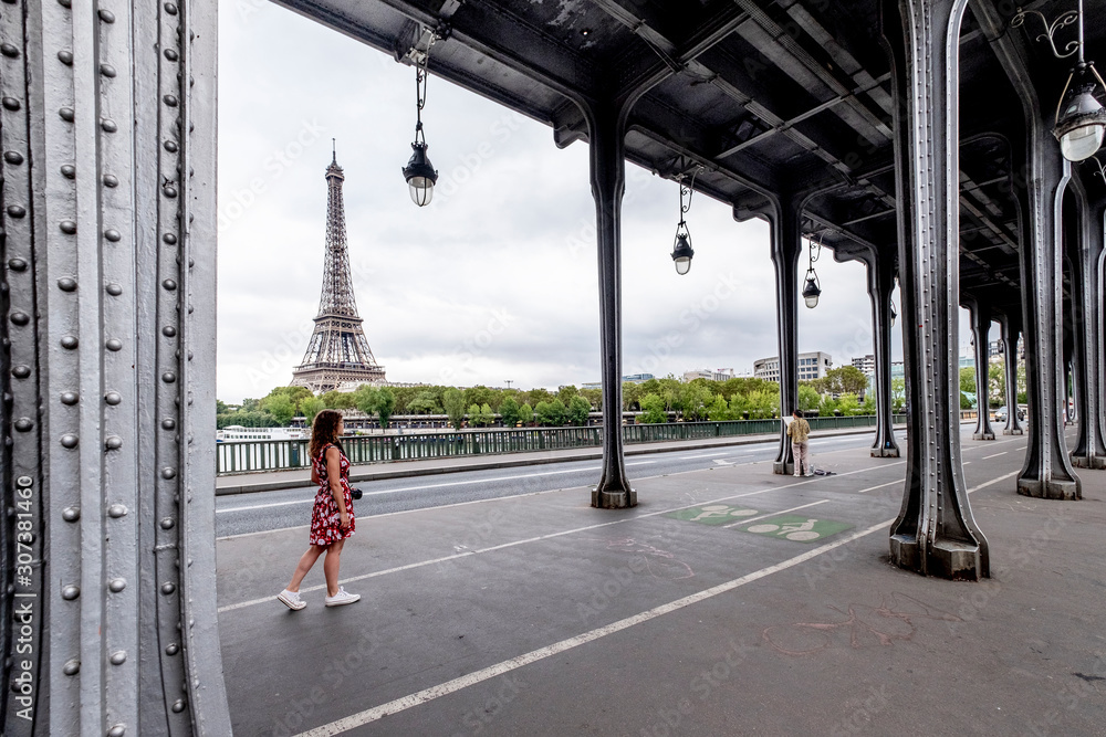 Woman in a floral dress and the Eiffel Tower in Paris in the background