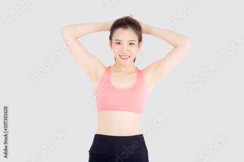 Beautiful portrait young asian woman standing workout stretch muscle arm with healthy isolated on white background, asia girl wear sport clothes exercise and yoga for health, wellness concept. © N_studio