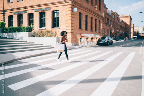 African American woman going on pedestrian crossing