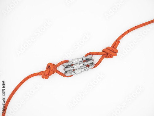 Two ropes connected by three carabiners. Triplet of the silver carabiners with lock and red ropes isolated on white. 