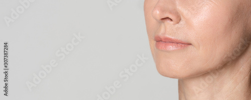 Perfect natural lips of middle aged woman photo