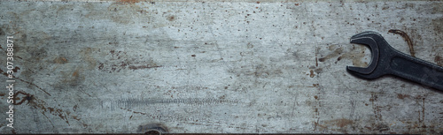 Canvas Print Steel textured metal sheet with rust and wrenches laid out on it
