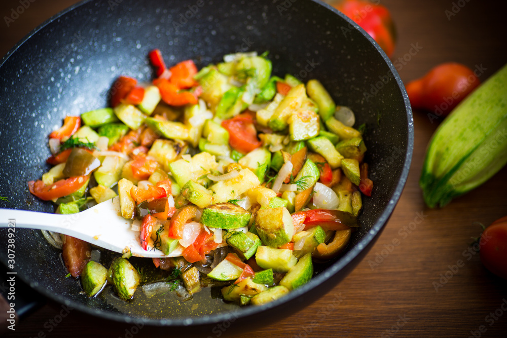 fried zucchini with red pepper, onions, tomatoes and other vegetables fried zucchini with red pepper, onions, tomatoes and other vegetables